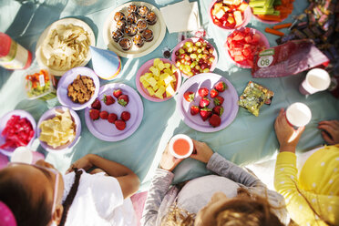 Overhead view of children eating at table in party - CAVF04751