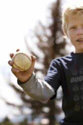 Close-up of boy holding baseball - CAVF04787