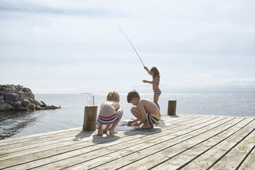 Fishing - girl fishing at the beach Stock Photo