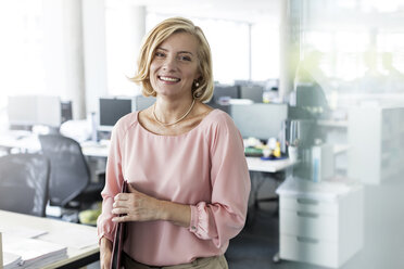 Portrait smiling businesswoman in office - CAIF09727