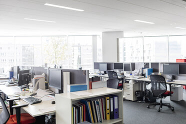 Computers and desks in vacant open plan office - CAIF09740