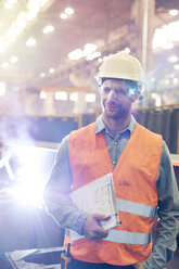 Steel worker with clipboard in factory - CAIF09787