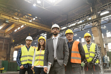 Portrait confident manager and steel worker team in factory - CAIF09814