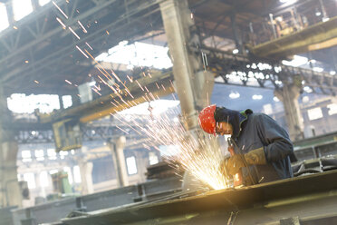 Welder using welding torch in steel factory - CAIF09843