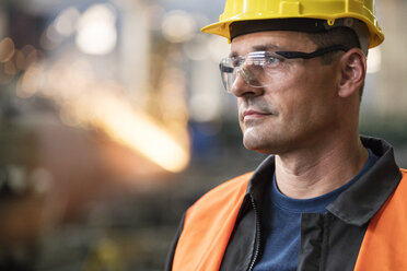 Close up pensive steel worker looking away - CAIF09863