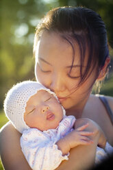 Close-up of woman embracing baby girl - CAVF04856