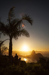 Silhouette of man against Sugarloaf Mountain during sunset - CAVF04936