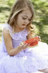 Cute girl eating watermelon in backyard - CAVF05020