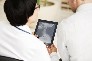 Doctors looking x-ray report in tablet computer - CAVF05035