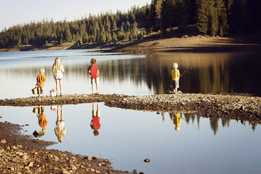 Rear view of friends fishing in lake - CAVF05051