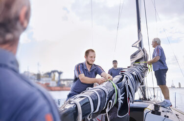 Men preparing sailing equipment - CAIF10159