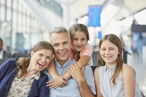 Portrait smiling family in airport departure area stock photo