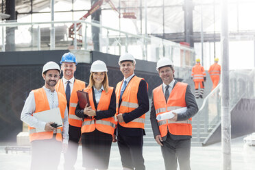 Portrait confident engineers and architects at construction site - CAIF10465