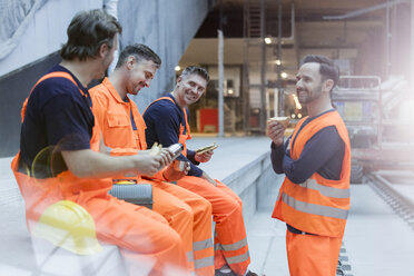 Construction workers eating lunch at construction site - CAIF10486