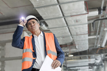 Foreman with flashlight at construction worker - CAIF10487