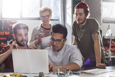 Treffen von Designern, die in der Werkstatt am Laptop arbeiten - CAIF10642