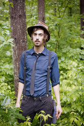 Portrait of man standing in forest - CAVF05422