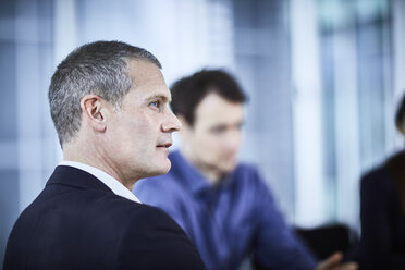 Attentive businessman listening in meeting - CAIF10650