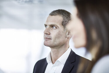 Attentive serious businessman listening in meeting - CAIF10652