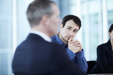 Attentive serious businessman listening to colleague in meeting - CAIF10687