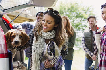 Freunde mit Hund auf dem Rücksitz eines Autos - CAIF10732