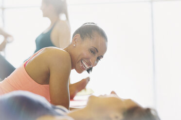 Smiling man and woman talking in gym Stock Photo by