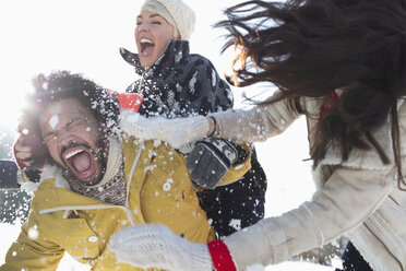 Friends enjoying snowball fight - CAIF10992