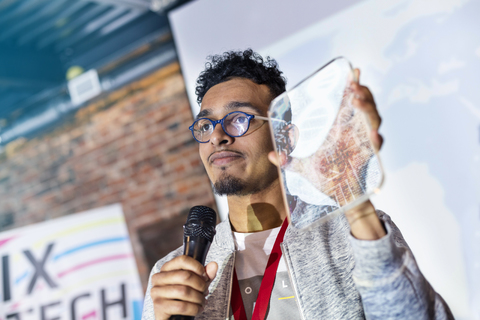 Speaker presenting prototype at technology conference stock photo