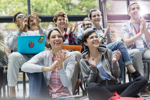 Smiling audience clapping at technology conference - CAIF11117