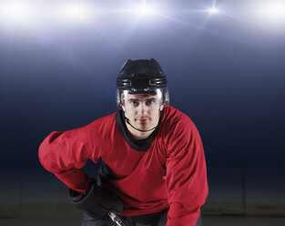 Portrait confident hockey player in red uniform - CAIF11169