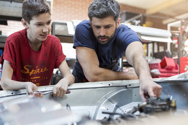 Vater und Sohn reparieren Automotor - CAIF11224