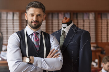 Man in blue pinstripe suit in tailors boutique stock photo