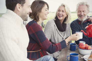 Couples drinking coffee on patio - CAIF11515