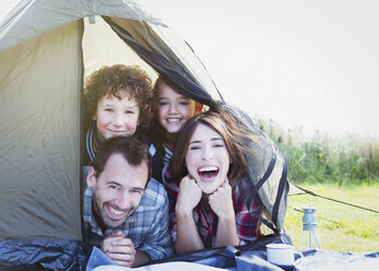 Portrait smiling family in tent - CAIF11528