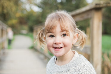 Portrait smiling toddler girl with pigtails - CAIF11548