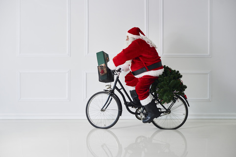 Weihnachtsmann fährt Fahrrad, lizenzfreies Stockfoto