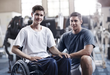 Portrait confident physical therapist and man in wheelchair - CAIF11687