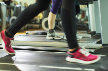 Frauenbeine beim Laufen auf dem Laufband im Fitnessstudio - CAIF11733