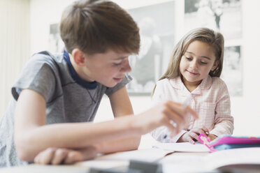 Brother helping sister with homework - CAIF11859