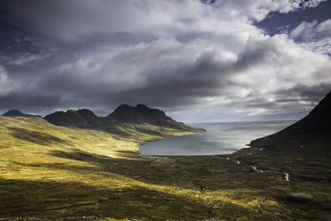 Sun shining along cliffs and shore, Veidileysa, West Fjords, Iceland - CAIF12257