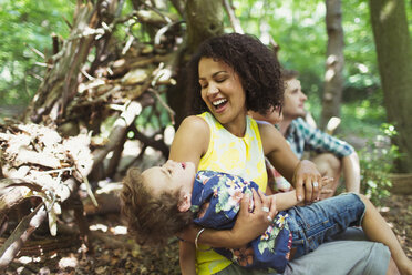 Playful mother and son in woods - CAIF12314