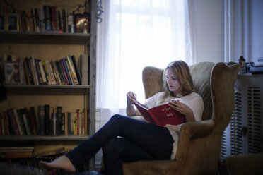 Woman reading book at home - CAVF05674