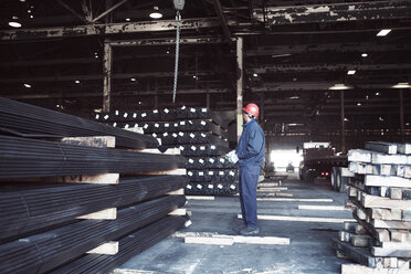 Side view of man working in warehouse - CAVF05695