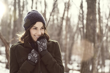 Happy woman looking away in forest - CAVF05727