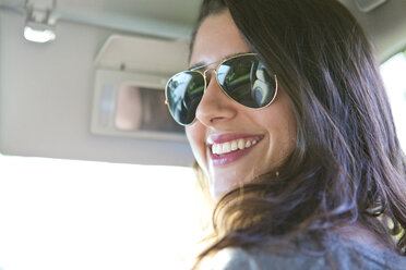 Porträt einer Frau mit Sonnenbrille, die im Auto sitzt - CAVF05906