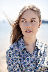 Woman looking away against beach - CAVF06000