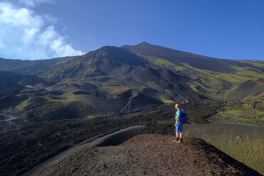 Italy, Sicily, Mount Etna, hiker looking at view - LBF01848