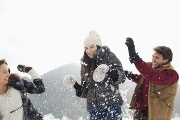 Couple enjoying snowball fight - CAIF12359