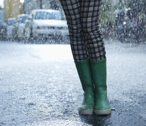 Regen fällt um eine Frau in Gummistiefeln - CAIF12440