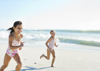 Girls running on beach - CAIF12461